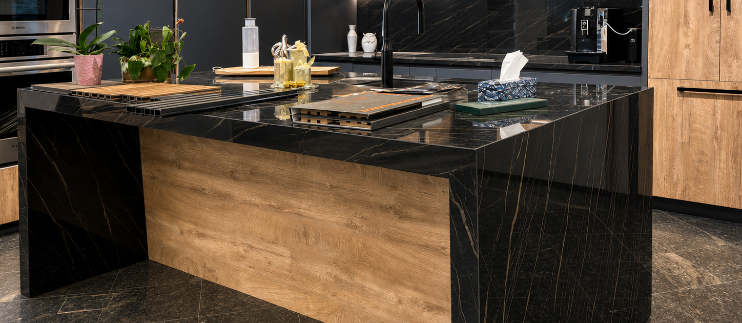 Book-matched black veined stone waterfall island in a contemporary kitchen